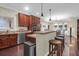 Well-lit kitchen featuring stainless steel appliances, cherry wood cabinets, bar stool seating and hardwood floors at 2494 Cape Rd, Johns Island, SC 29455