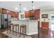 Kitchen with cherry wood cabinets, stainless steel appliances, barstool seating, and hardwood floors at 2494 Cape Rd, Johns Island, SC 29455