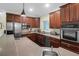 Contemporary kitchen featuring stainless steel appliances, cherry wood cabinets, and hardwood floors at 2494 Cape Rd, Johns Island, SC 29455