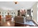 Bright living room with hardwood floors, stone fireplace, built-in bookshelves and a view into the dining area at 2494 Cape Rd, Johns Island, SC 29455