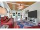 Cozy living room boasts a wood-planked ceiling, arched windows, and ample natural light at 2494 Cape Rd, Johns Island, SC 29455