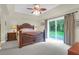 Comfortable main bedroom features a tray ceiling, carpeted floors, and a sliding glass door to the backyard at 2494 Cape Rd, Johns Island, SC 29455