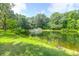 Picturesque pond with fountain feature amid a lush green landscape at 2494 Cape Rd, Johns Island, SC 29455