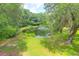 Beautiful pond featuring a fountain surrounded by lush greenery and trees in a serene setting at 2494 Cape Rd, Johns Island, SC 29455
