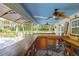 Poolside bar with ceiling fans, a bar, and a view of the pool and surrounding yard at 2494 Cape Rd, Johns Island, SC 29455