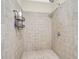Tiled shower stall with shower head and storage shelves, designed for convenience and efficiency at 2494 Cape Rd, Johns Island, SC 29455