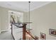 Staircase with wooden railings and a chandelier, leading to an open area and inviting further exploration at 2494 Cape Rd, Johns Island, SC 29455