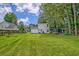 Well-maintained backyard with a shed and green lawn, enclosed by a wooden fence and mature trees at 2538 Wayne Scott Ct, Charleston, SC 29414