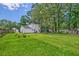 Expansive backyard featuring lush green grass and mature trees, providing a serene outdoor setting at 2538 Wayne Scott Ct, Charleston, SC 29414