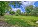 Expansive backyard offering ample green space with trees and a wooden fence at 2538 Wayne Scott Ct, Charleston, SC 29414