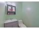 Bathroom featuring a gray vanity, mirror, and modern toilet against mint green walls at 2538 Wayne Scott Ct, Charleston, SC 29414