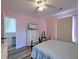 Comfortable pink bedroom with bed, dresser, TV, and ceiling fan at 2538 Wayne Scott Ct, Charleston, SC 29414