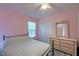 Bedroom with pink walls featuring a cozy bed, closet and dresser with wicker drawers at 2538 Wayne Scott Ct, Charleston, SC 29414