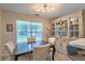 Elegant dining room featuring a wooden table, cushioned chairs, and a vintage hutch for a warm, inviting space at 2538 Wayne Scott Ct, Charleston, SC 29414