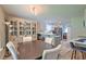 Dining room with wood table, upholstered chairs, and a large hutch for storage and display at 2538 Wayne Scott Ct, Charleston, SC 29414
