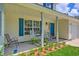 Cozy front porch with rocking chairs, decorative shutters, and a well-maintained garden bed at 2538 Wayne Scott Ct, Charleston, SC 29414