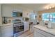 Bright kitchen with stainless steel appliances, updated cabinetry, and durable countertops with an eat-in area at 2538 Wayne Scott Ct, Charleston, SC 29414