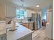 Well-lit kitchen with marble countertops, stainless steel appliances, and a window overlooking the backyard at 2538 Wayne Scott Ct, Charleston, SC 29414
