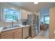 Bright kitchen featuring stainless steel appliances, a modern sink, and a view into the living room at 2538 Wayne Scott Ct, Charleston, SC 29414