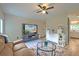 Inviting living room featuring a cozy sofa, entertainment center, and a view into the kitchen area at 2538 Wayne Scott Ct, Charleston, SC 29414
