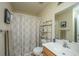 Functional bathroom with a vanity, mirror, patterned shower curtain, and storage shelving at 2601 Riverridge Ct # A, Moncks Corner, SC 29461