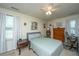 Inviting bedroom with large windows, neutral walls, comfortable bed, and classic wooden furniture at 2601 Riverridge Ct # A, Moncks Corner, SC 29461