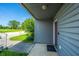 Inviting front porch entrance showcasing gray siding and a brown door with a view of the outdoors at 2601 Riverridge Ct # A, Moncks Corner, SC 29461