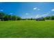 Expansive green space with beautiful trees in the background, perfect for recreational activities and relaxation at 2601 Riverridge Ct # A, Moncks Corner, SC 29461