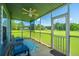 Relaxing screened porch with ceiling fan, blue outdoor rug, and comfortable seating overlooking the greenery at 2601 Riverridge Ct # A, Moncks Corner, SC 29461