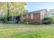 A brick home with a screened in porch overlooking the spacious green backyard at 2736 Star Drive, North Charleston, SC 29406