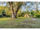 A spacious backyard with a large tree and an outbuilding at 2736 Star Drive, North Charleston, SC 29406