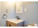 Bathroom featuring a wood vanity with white countertop, faucet, and open mirror cabinet at 2736 Star Drive, North Charleston, SC 29406