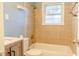 Cozy bathroom featuring a tiled shower and tub, window, and wood vanity at 2736 Star Drive, North Charleston, SC 29406