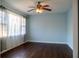 Bright bedroom featuring hardwood floors, ceiling fan with light, and large window at 2736 Star Drive, North Charleston, SC 29406