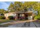 Charming brick home featuring a covered carport, a well-manicured lawn, and classic architectural details at 2736 Star Drive, North Charleston, SC 29406
