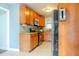 Galley kitchen featuring wood cabinets, granite counters, tile floors, and stainless steel appliances at 2736 Star Drive, North Charleston, SC 29406