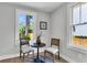 Cozy breakfast nook with hardwood floors, two large windows overlooking backyard, and a rustic table setting at 2949 Alabama Dr, North Charleston, SC 29405