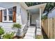 The front entrance features a covered porch with freshly painted stairs, new railings, and a charming baby blue ceiling at 2949 Alabama Dr, North Charleston, SC 29405
