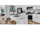 Modern kitchen with white cabinets, stainless steel appliances, a quartz countertop island, and stylish stools at 2949 Alabama Dr, North Charleston, SC 29405