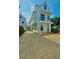 Charming two-story home with white siding, a small balcony, and a welcoming blue front door at 30 Nats Ct, Charleston, SC 29403