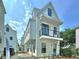 Charming two-story home with white siding, a small balcony, and a welcoming blue front door at 30 Nats Ct, Charleston, SC 29403