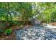 Secluded backyard featuring a shaded seating area, wooden shed, and gravel ground at 3002 Waterway Blvd, Isle of Palms, SC 29451