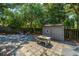 Inviting backyard with a shaded patio area, outdoor furniture, and a charming shed at 3002 Waterway Blvd, Isle of Palms, SC 29451