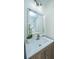 Bathroom vanity with a white countertop, sink, mirror, and decorative orchid at 3002 Waterway Blvd, Isle of Palms, SC 29451