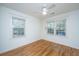 Well-lit bedroom showcasing hardwood floors and two windows that bring in plenty of natural light at 3002 Waterway Blvd, Isle of Palms, SC 29451