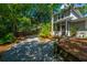Home exterior showcasing beautiful landscaping, a screened-in porch, and gravel driveway at 3002 Waterway Blvd, Isle of Palms, SC 29451