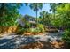 Charming home exterior with well-maintained landscaping and a gravel driveway at 3002 Waterway Blvd, Isle of Palms, SC 29451