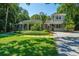 Charming home exterior with a well-maintained lawn, stepping stone pathway, and lush landscaping at 3002 Waterway Blvd, Isle of Palms, SC 29451