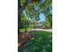 A swing hangs from a grand oak, framing a view of the charming two-story home with a well-manicured lawn at 3002 Waterway Blvd, Isle of Palms, SC 29451