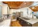 Kitchen with wood ceiling, center island with cooktop, stainless appliances, and hardwood floors at 3002 Waterway Blvd, Isle of Palms, SC 29451